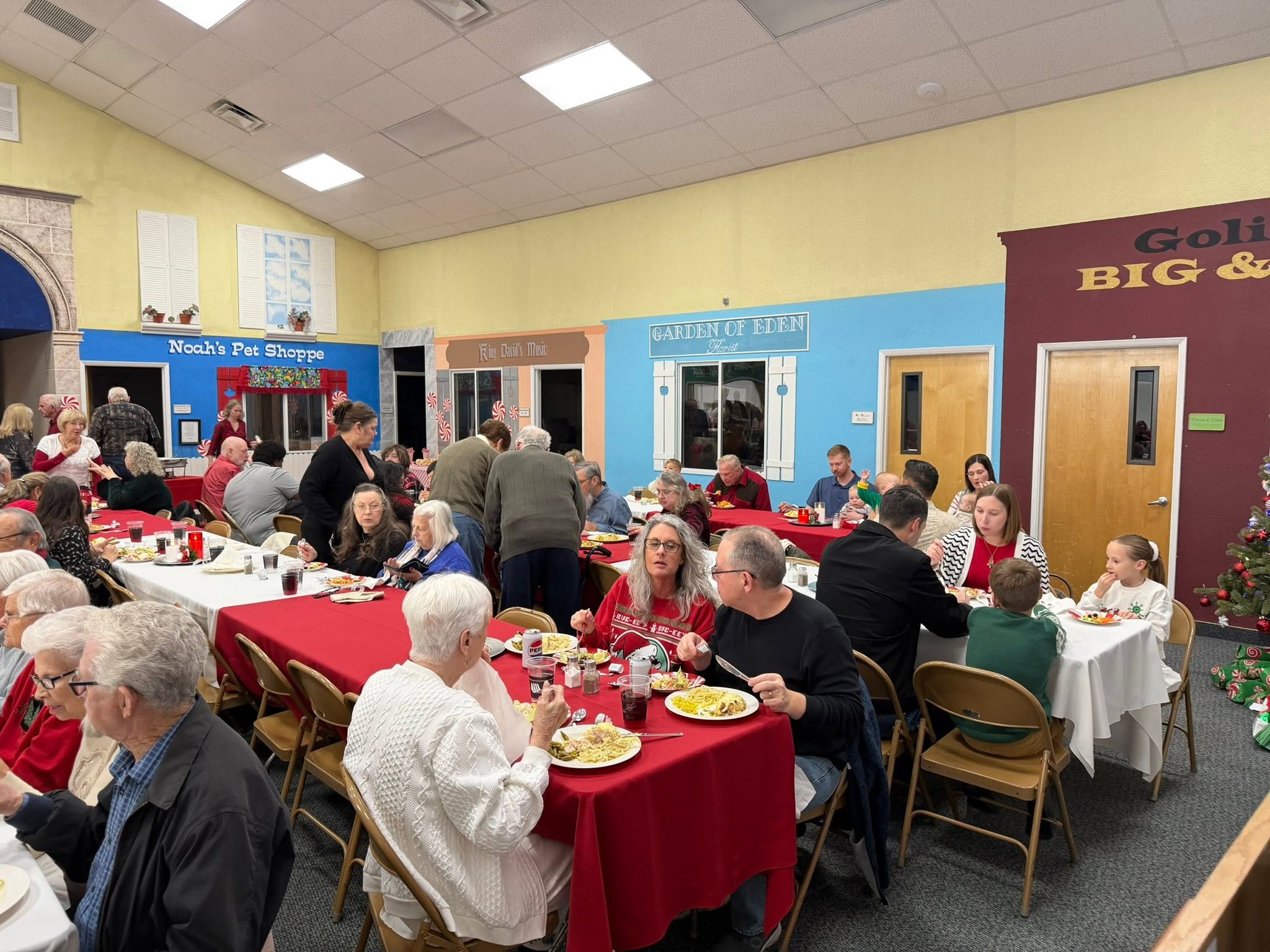 Church family members sharing a meal around tables at Ham Lane’s 2025 Christmas dinner